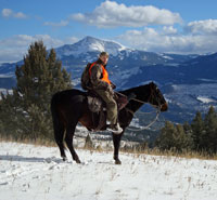 Hunter in front of snow capped peaks